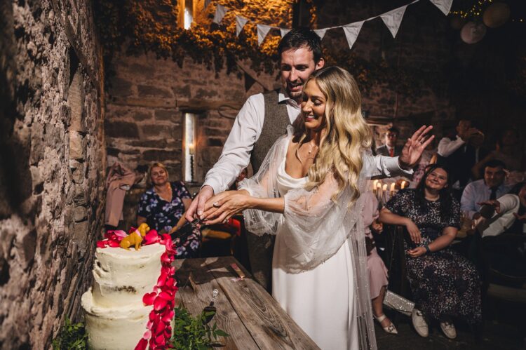 bride and groom cutting the cake at Lyde Court