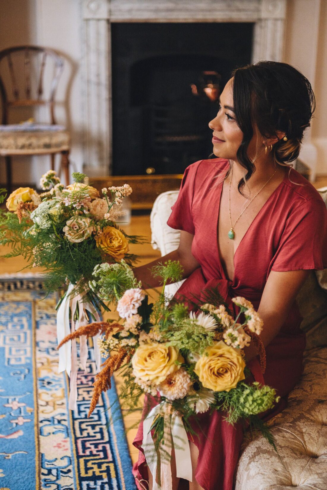 bridesmaid holding a bouquet in the main suite at Homme House