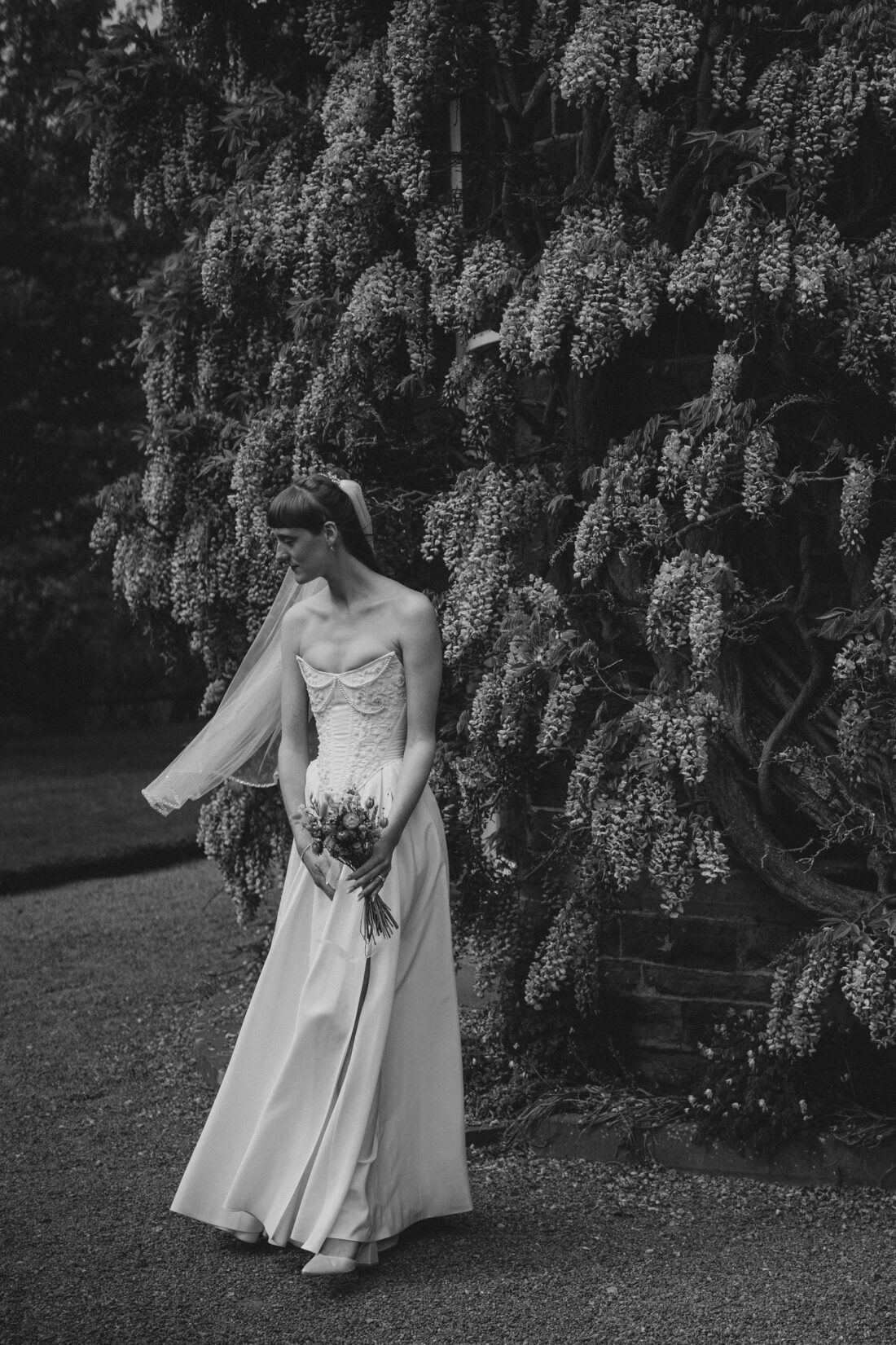 Bride near wisteria at Brobury House wedding photography