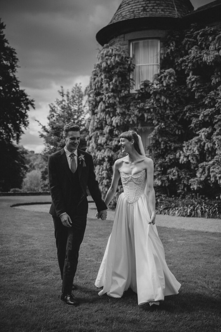 bride and groom walking in the Brobury House gardens