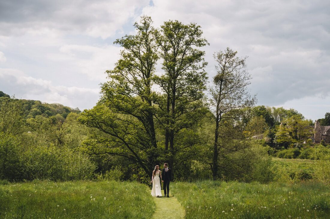 bride and groom walking in the Brobury House gardens
