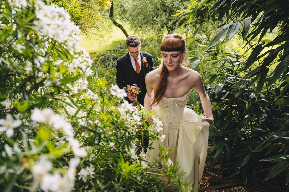 bride and groom walking in the Brobury House gardens