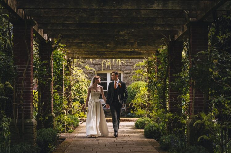 bride and groom walking in the Brobury House gardens