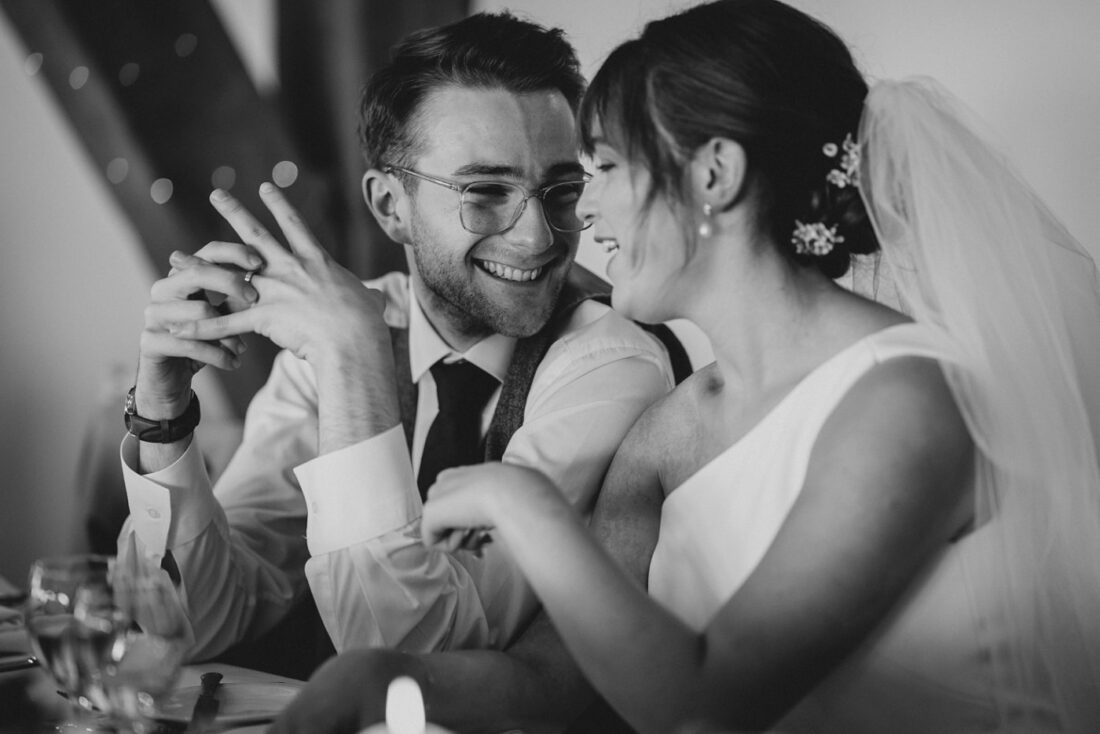 bride and groom smiling and chatting during the wedding breakfast