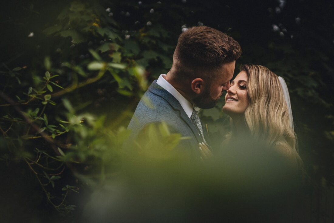 bride and groom kissing surrounded by the trees at Deer Park