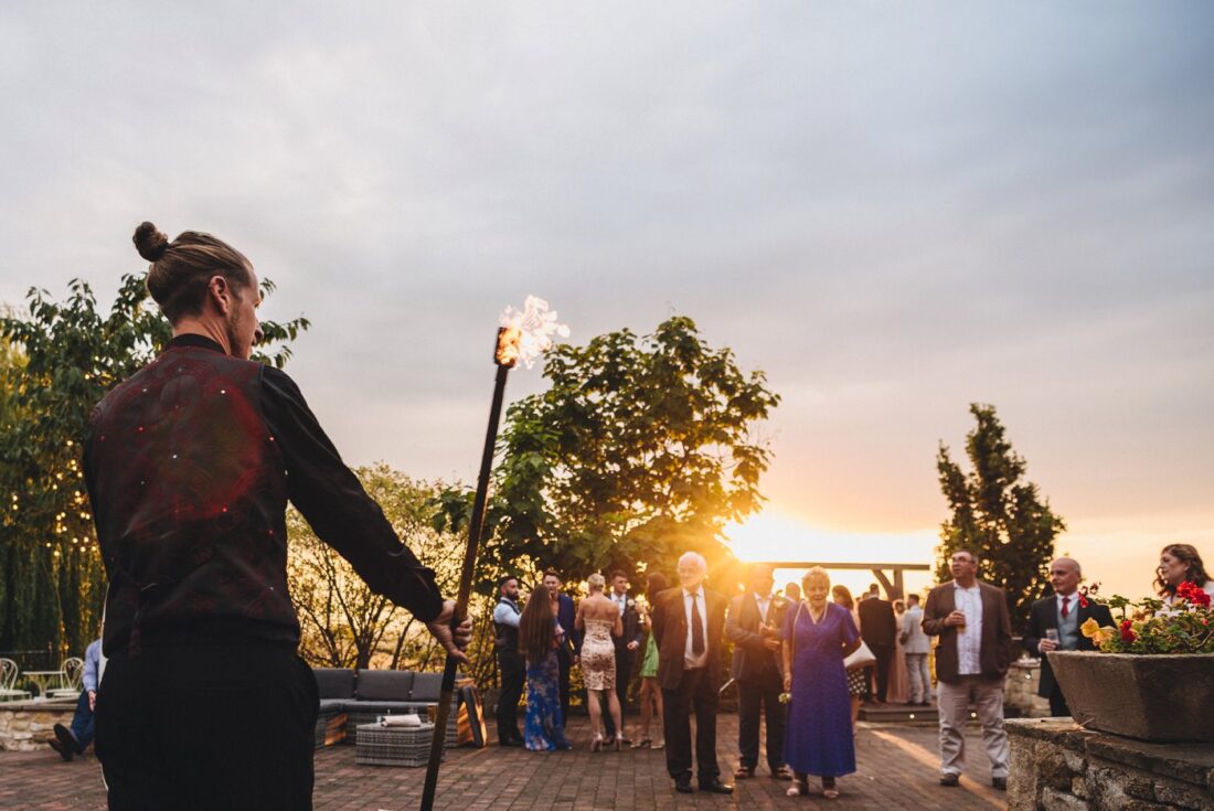 golden hour at Deer Park, fire dancer performing and wedding guests watching