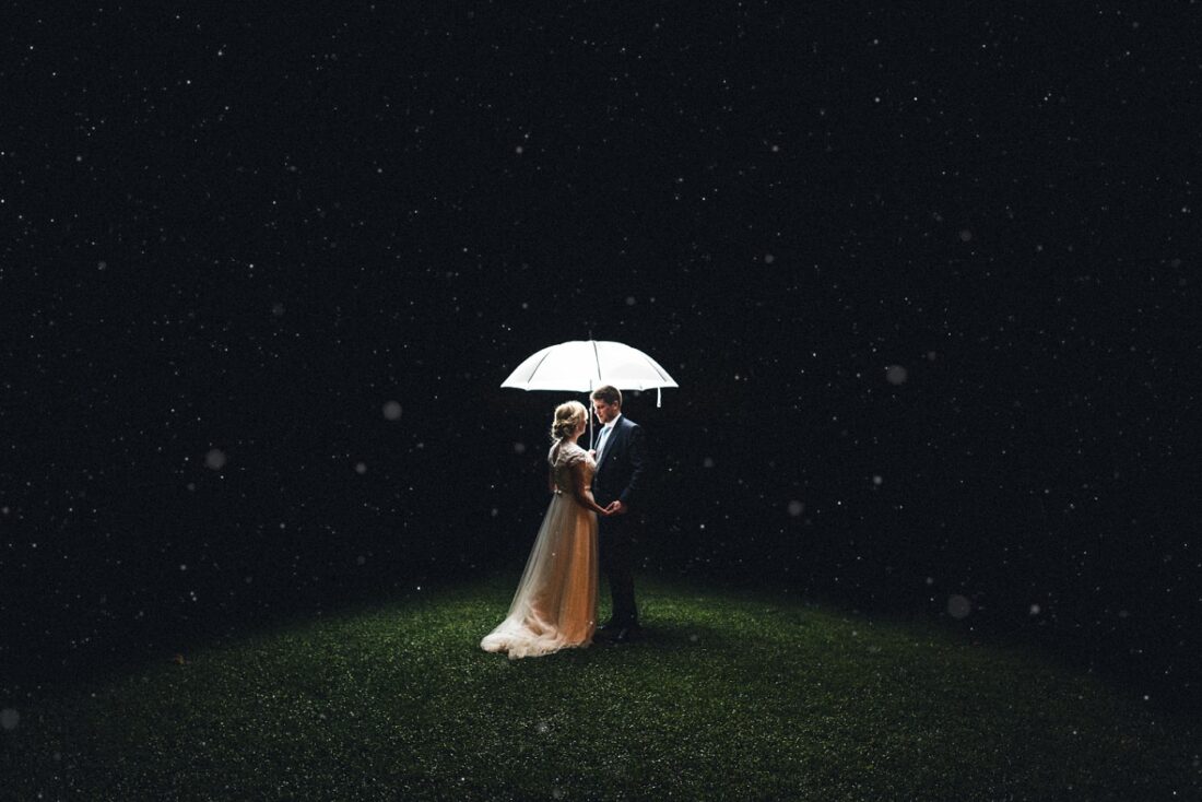 couple standing under the umbrella in the rain at Deer Park