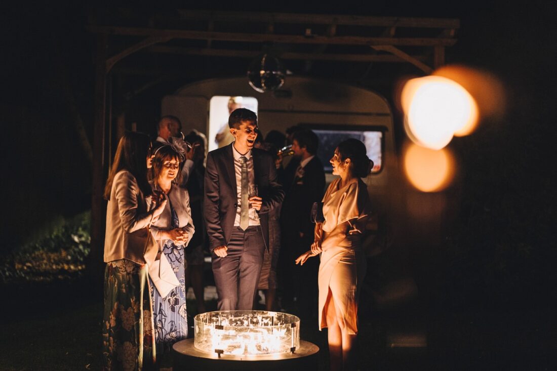 wedding guests chatting outside at Birtsmorton Court at night