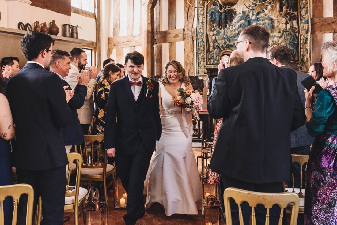 bride and groom just married and walking together back up the aisle after the civil ceremony at Birtsmorton Court