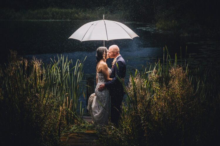 Lyde Arundel weddings - just married couple during their photo session in the rain