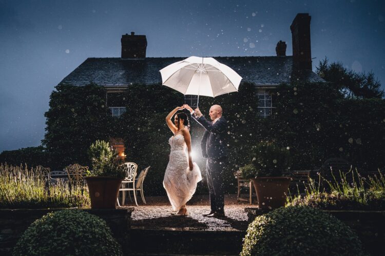 Lyde Arundel weddings - just married couple during their photo session in the rain