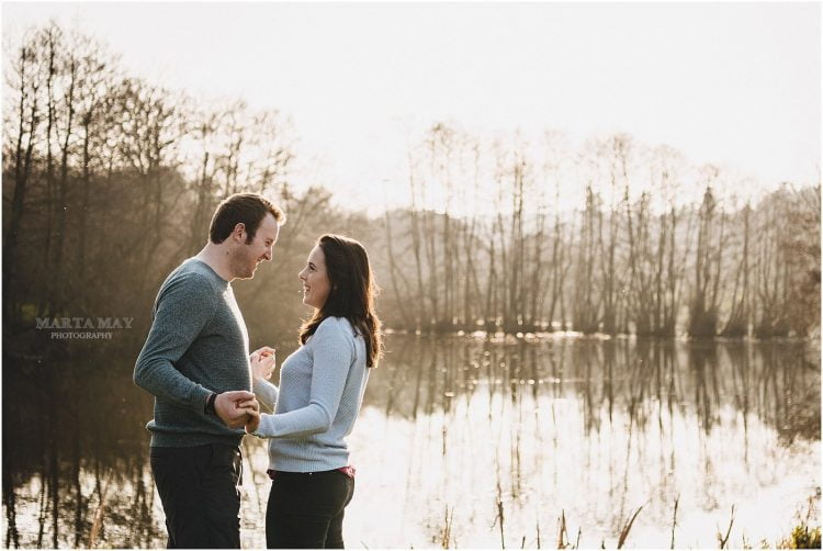 spring engagement session Herefordshire Cotswolds, couple holding hands in front of a lake