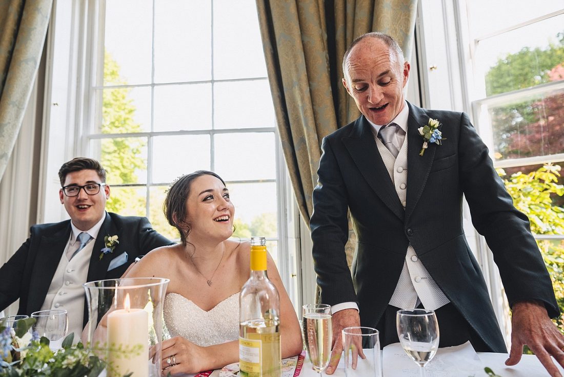 father of the bride giving the speech at Homme House bride and groom listening next to him