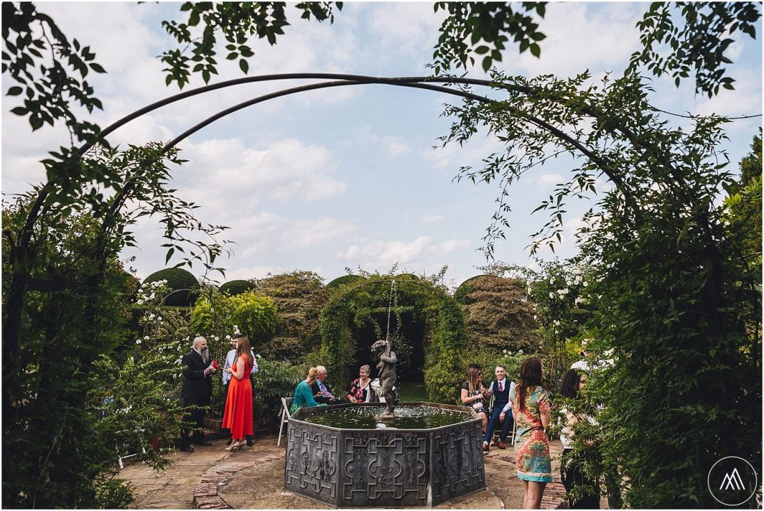 the fountain and wedding guests in the white garden at Birtsmorton Court