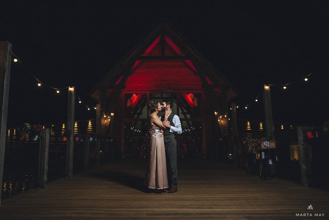 Mill Barns wedding photography bride and groom standing at night in front of the venue and kissing, shropshire wedding venues