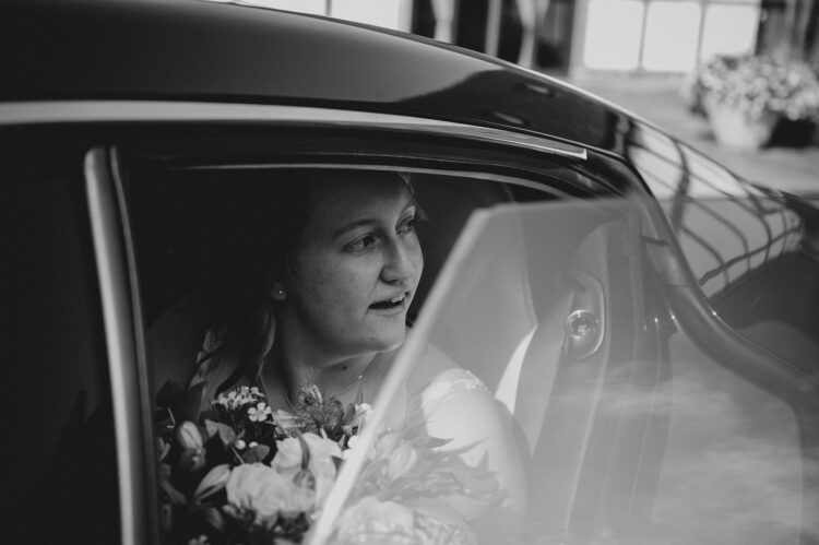 bride and groom in the car at redhouse barn