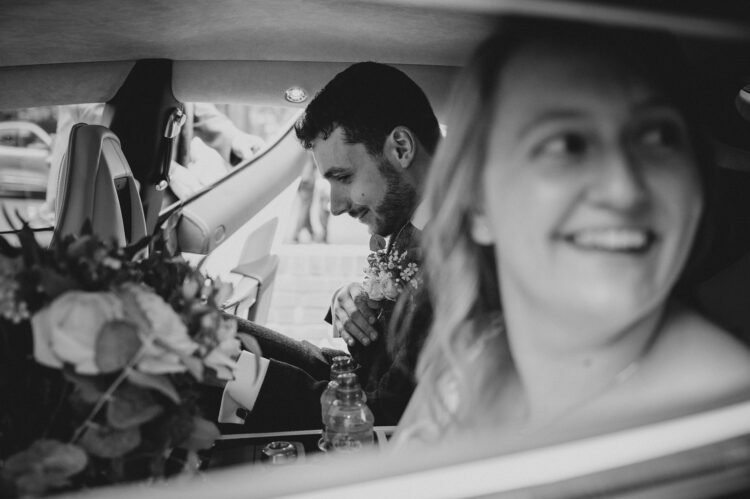 bride and groom in the car at redhouse barn