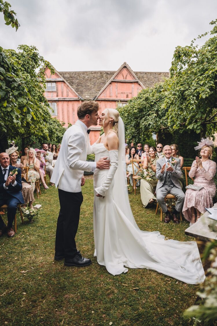 bride and groom's first kiss at Pauntley Court