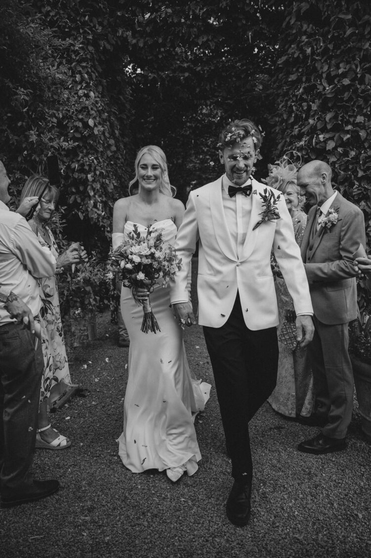 bride and groom enjoying the confetti moment
