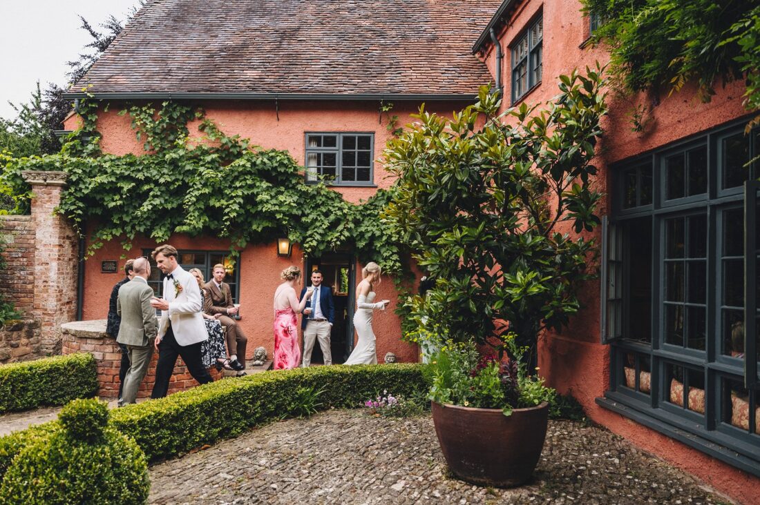 wedding guests having a great time during reception drinks at Pauntley court gloucestershire