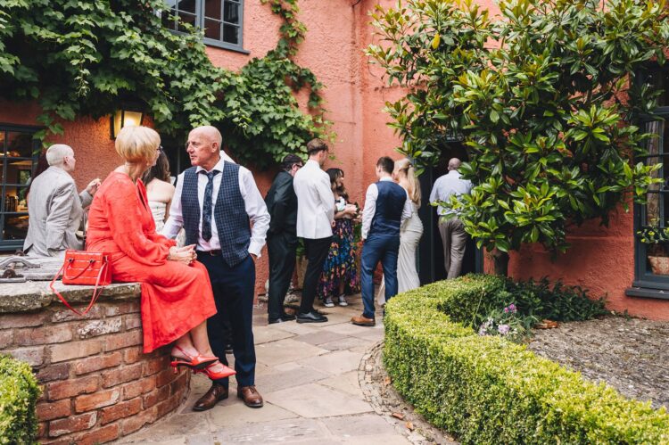 wedding guests having a great time during reception drinks at Pauntley court gloucestershire