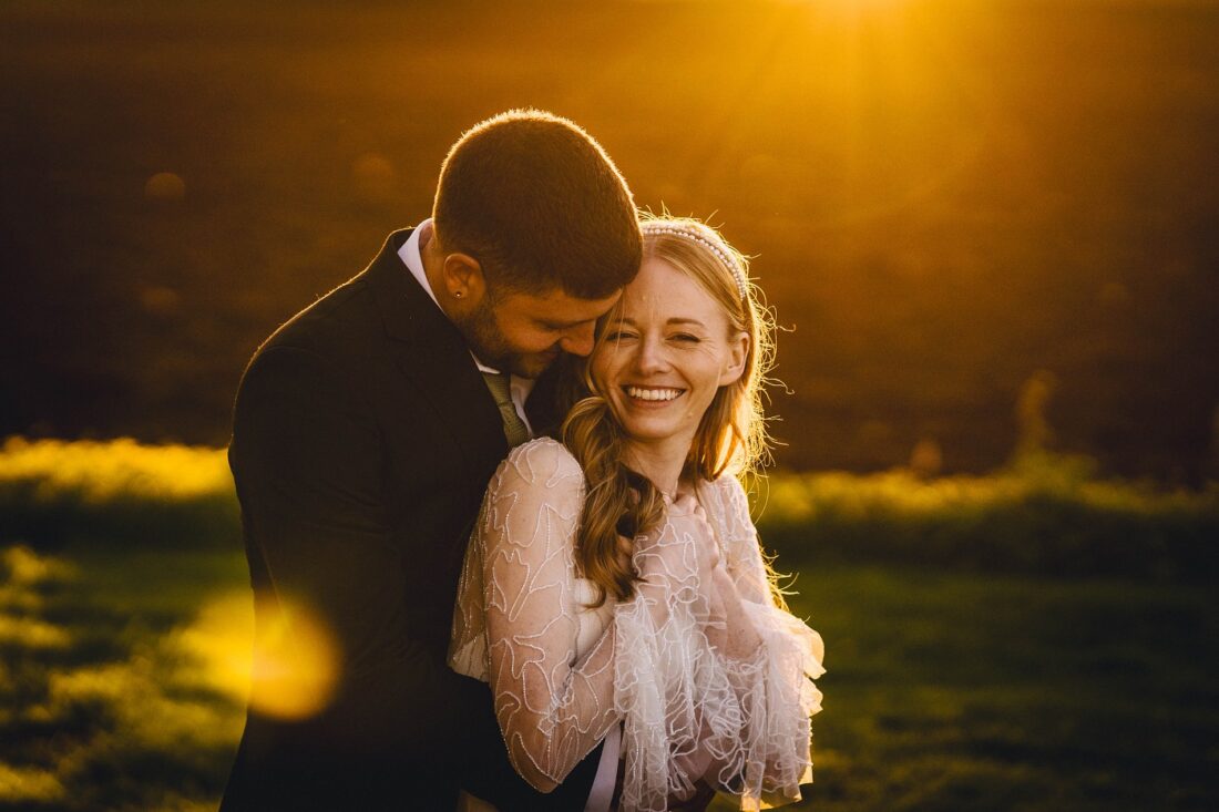 bride and groom hugging in the golden hour at Lapstone Barn, Cotswolds