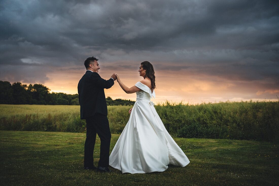 bride and groom dancing in the sunset at lapstone barn