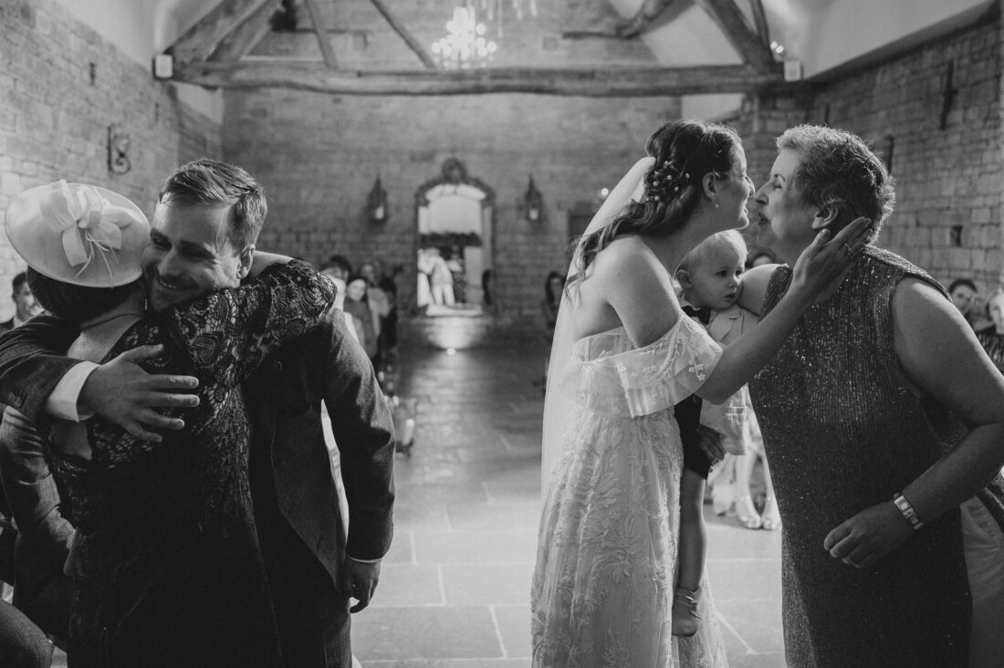 bride and groom kissing their mums during ceremony at Blackwell Grange