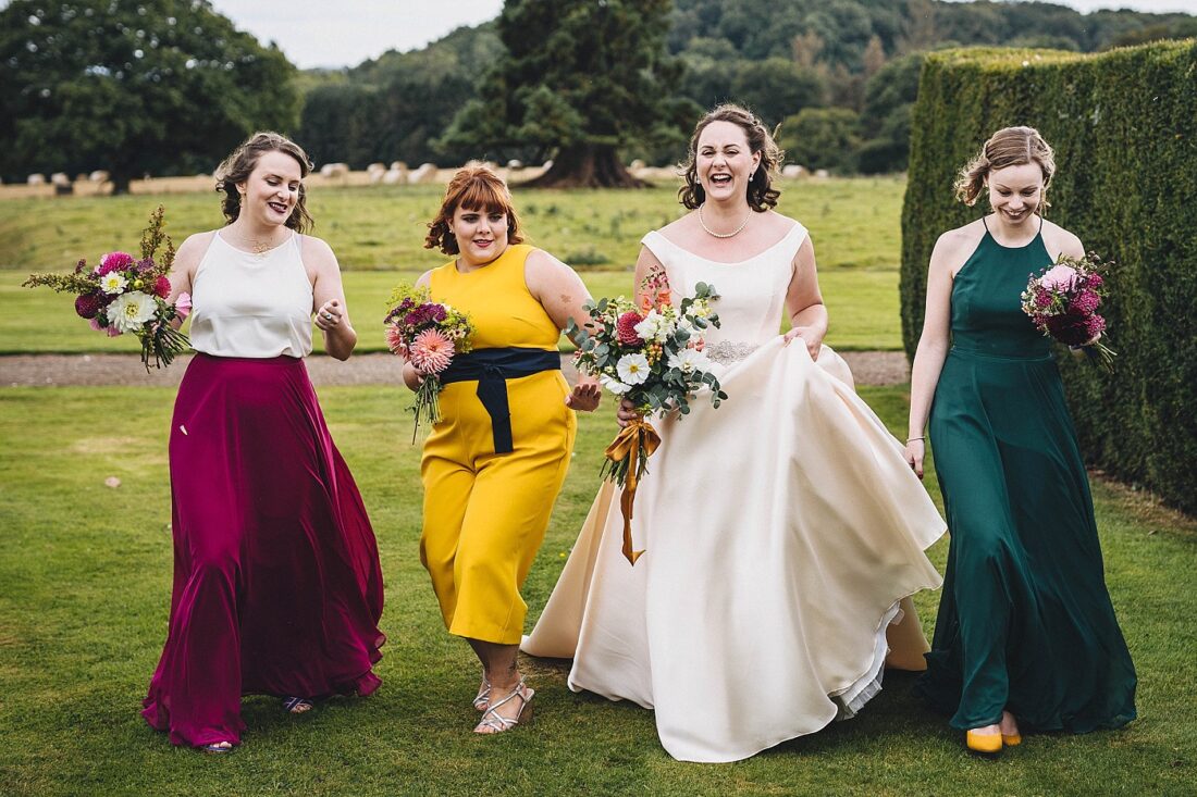 broadfield court wedding photography bride and bridesmaids walking towards the venue