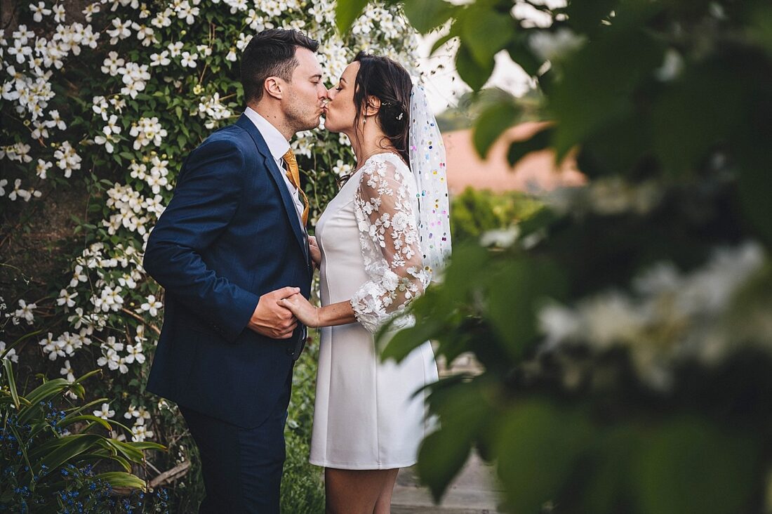 bride and groom surrounded by blossom, spring wedding at Brinsop court, Hereford