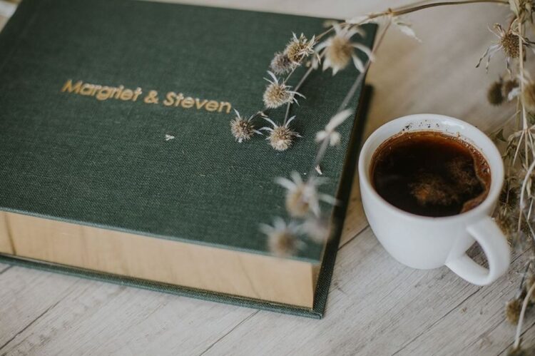 wedding album on a coffee table with coffee