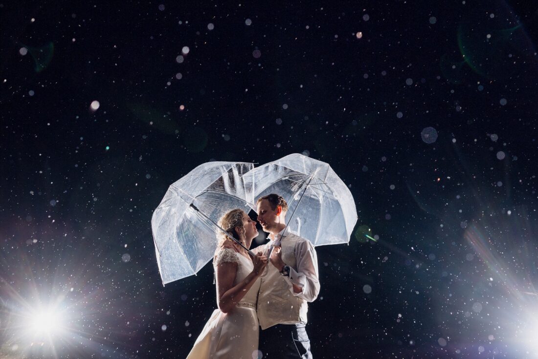 couple in the rain at Brinsop Court, beautiful rainy wedding picture