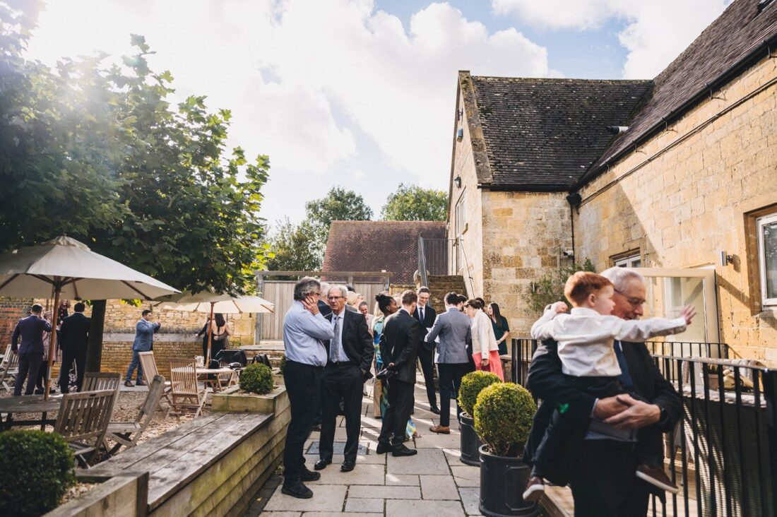 wedding guests mingling in the courtyard at lapstone barn