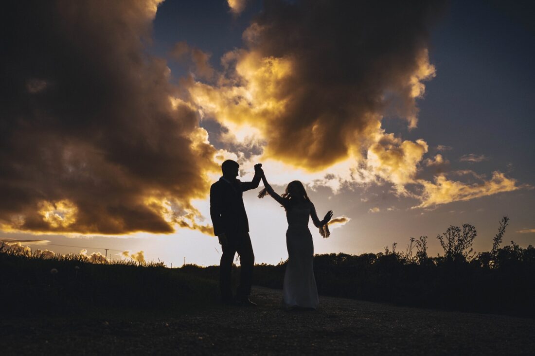 creative wedding photography at lapstone barn, a silouhette of bride and groom dancing in the sunset