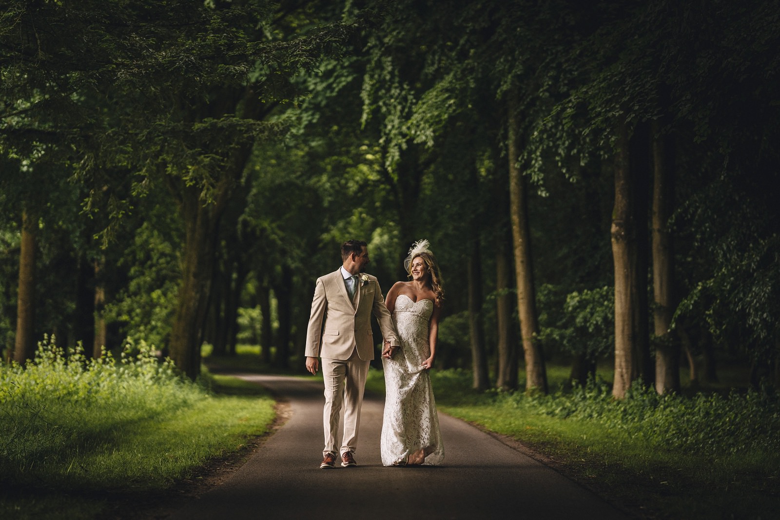 Bowood wedding photography bride and groom strolling through the woods