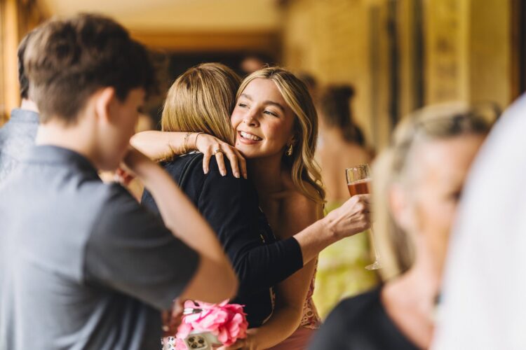 wedding guests hugging and chatting at bowood