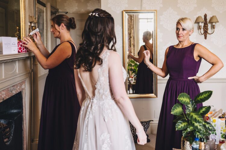 bridesmaids getting ready in one of the rooms at Brockencote Hall