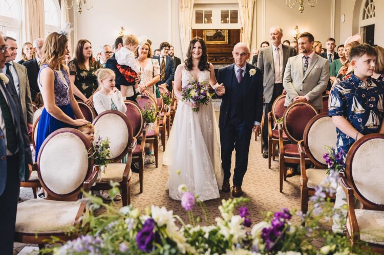 bride entering the ceremony room with her dad