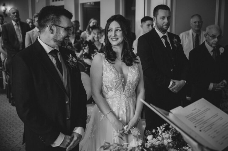 bride and groom's happy looks during the ceremony