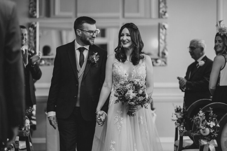 just married couple leaving the room at Brockencote Hall