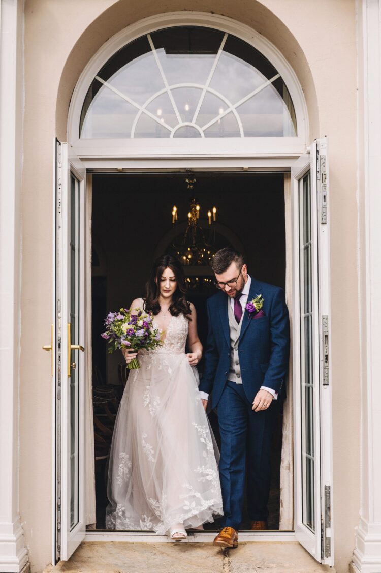 just married couple leaving the room at Brockencote Hall