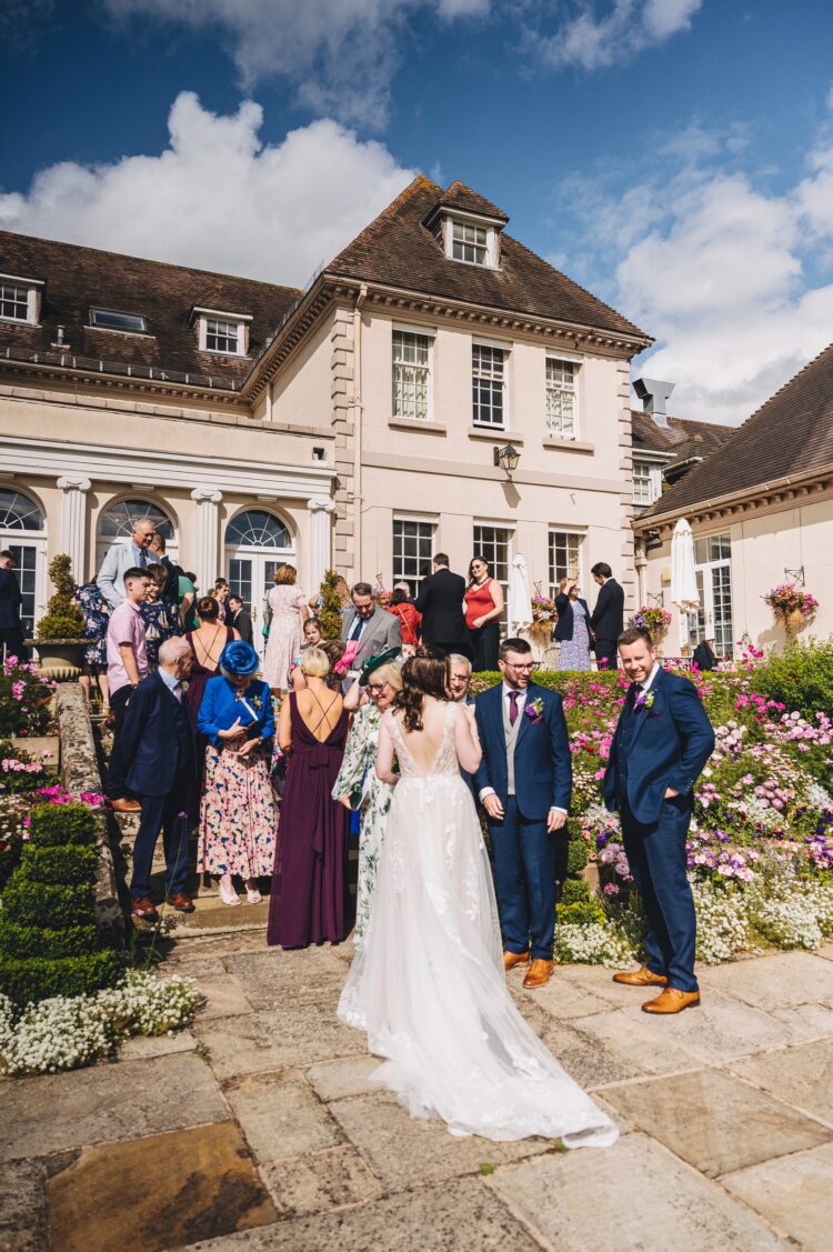 wedding guests mingling during reception drinks at Brockencote Hall