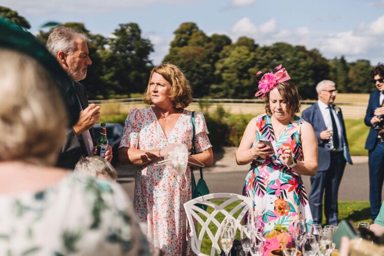 wedding guests mingling during reception drinks at Brockencote Hall