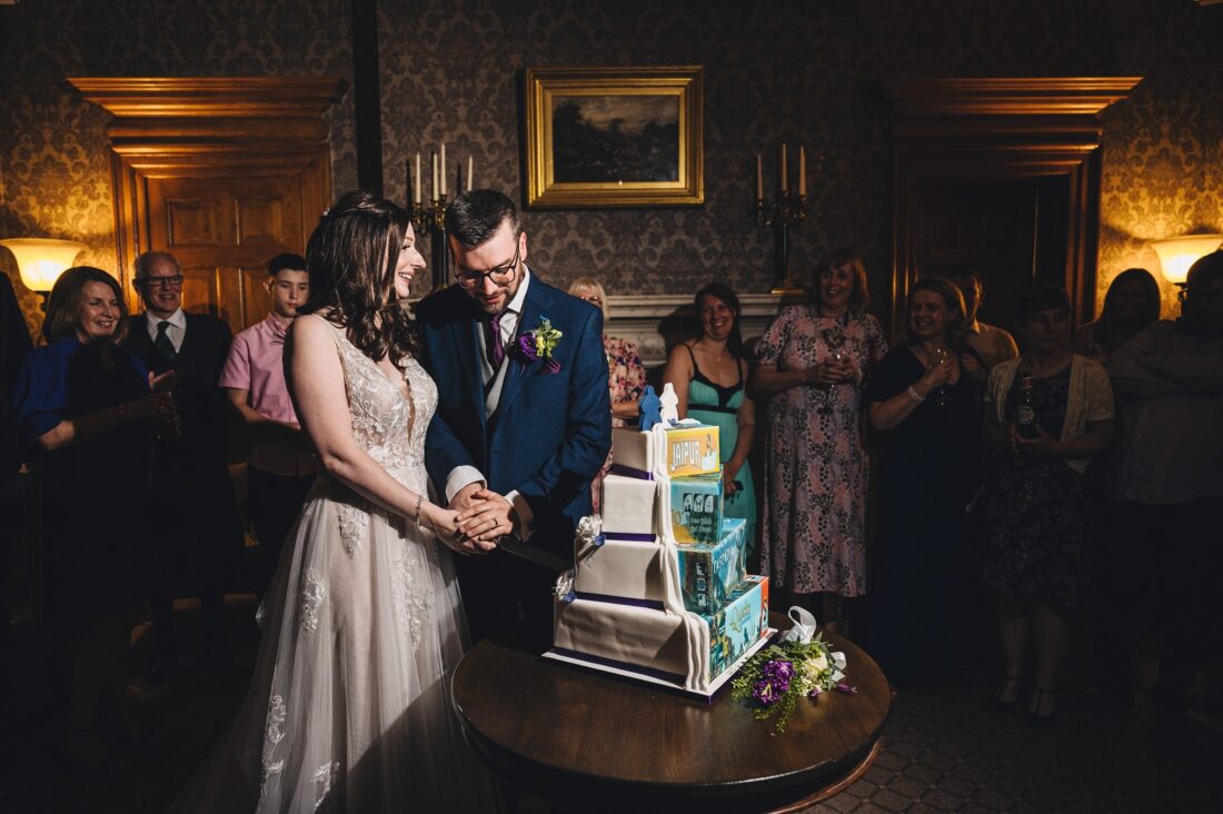 bride and groom cut the cake at Brockencote Hall