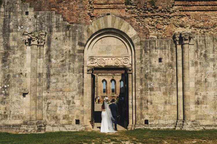 bride entering ceremony at San Galgano Abbey, Tuscany