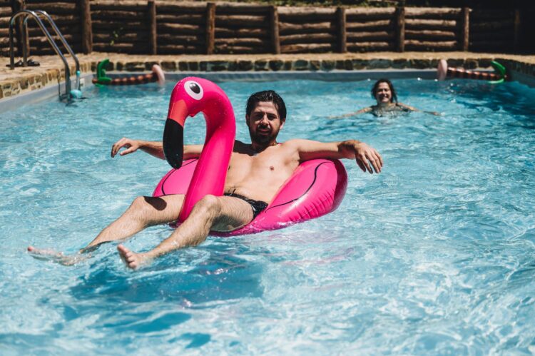 groom chilling in the pool after a wedding at Villa Podernovo