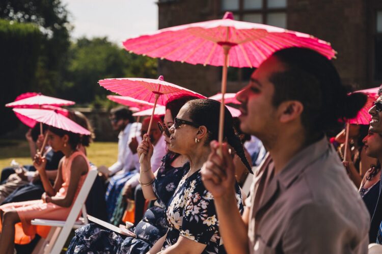 LGBTQ wedding photographer guests at outdoor hindu wedding ceremony at How Caple Court
