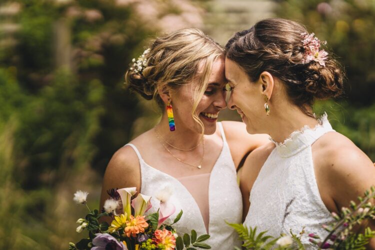 LGBTQ wedding photographer two brides radiating happiness and love