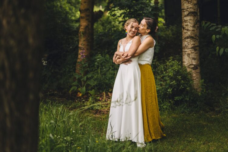 LGBTQ wedding photographer two brides radiating happiness and love