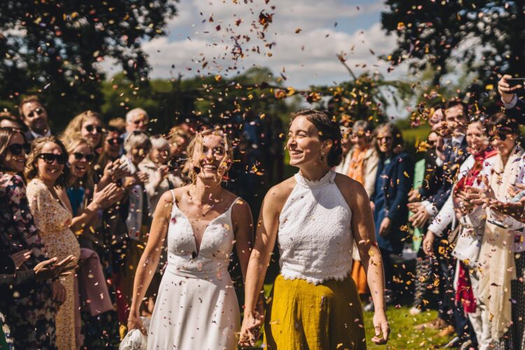 LGBTQ wedding photographer brides enjoying the confetti moment